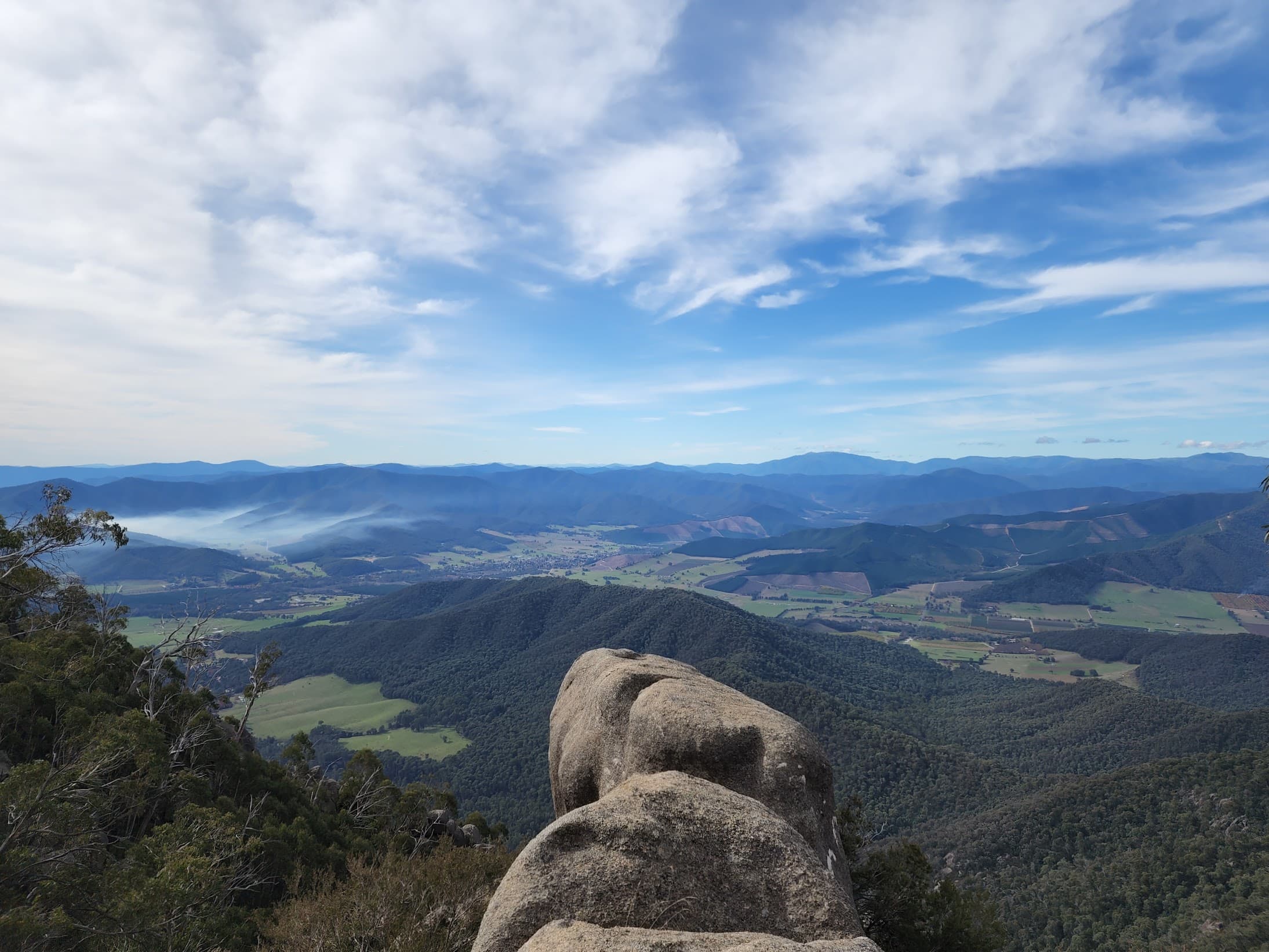 Panoramic view over a forested valley from a granite outcrop